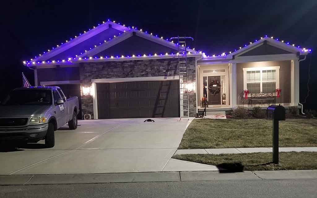 Christmas lights and ornaments installed on a tree in Kansas City Home